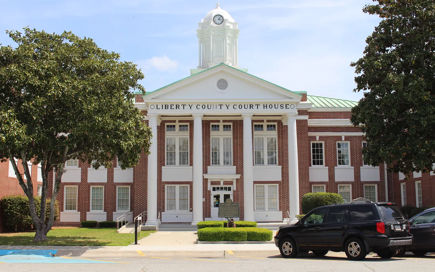 The columned front and cupola of the Liberty County Courthouse in downtown Hinesville, Georgia