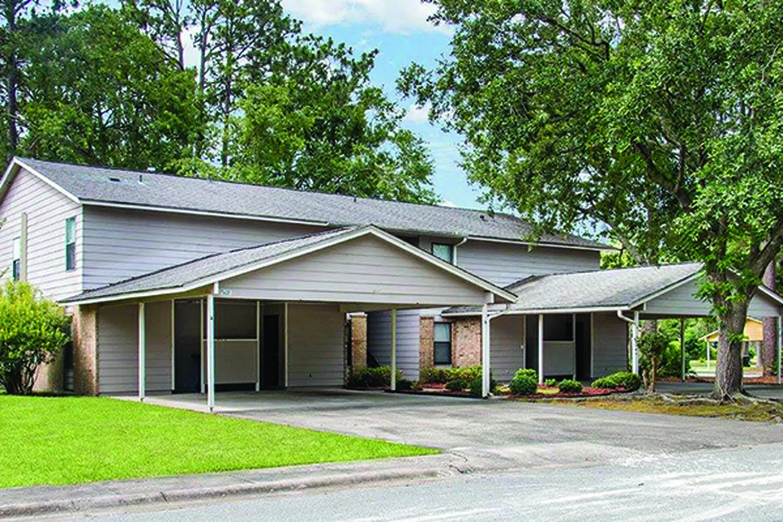Duplex family homes with carports and a front lawn on Fort Stewart