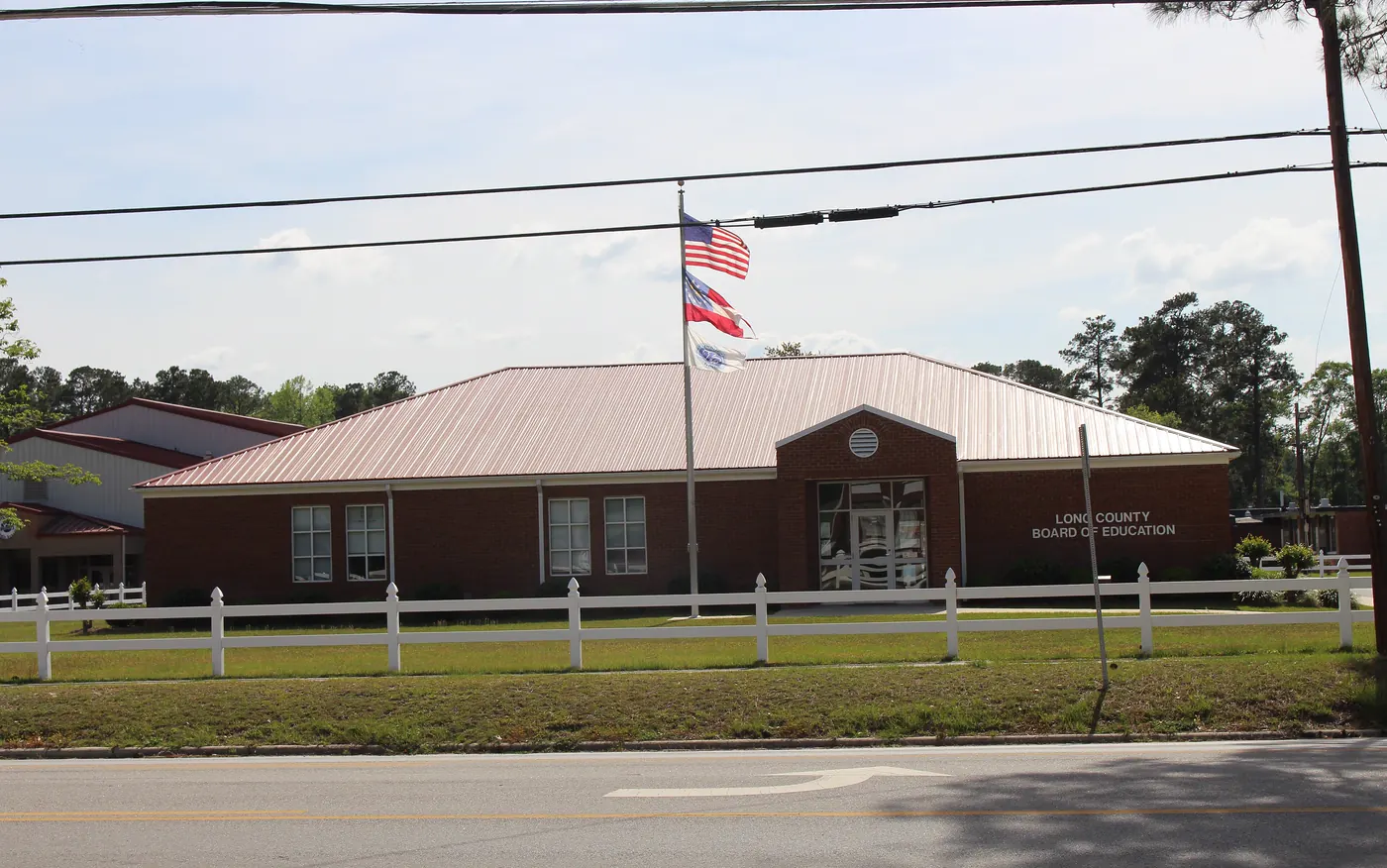 The Long County School District office in Ludowici, a brick building with a metal roof and a flagpole