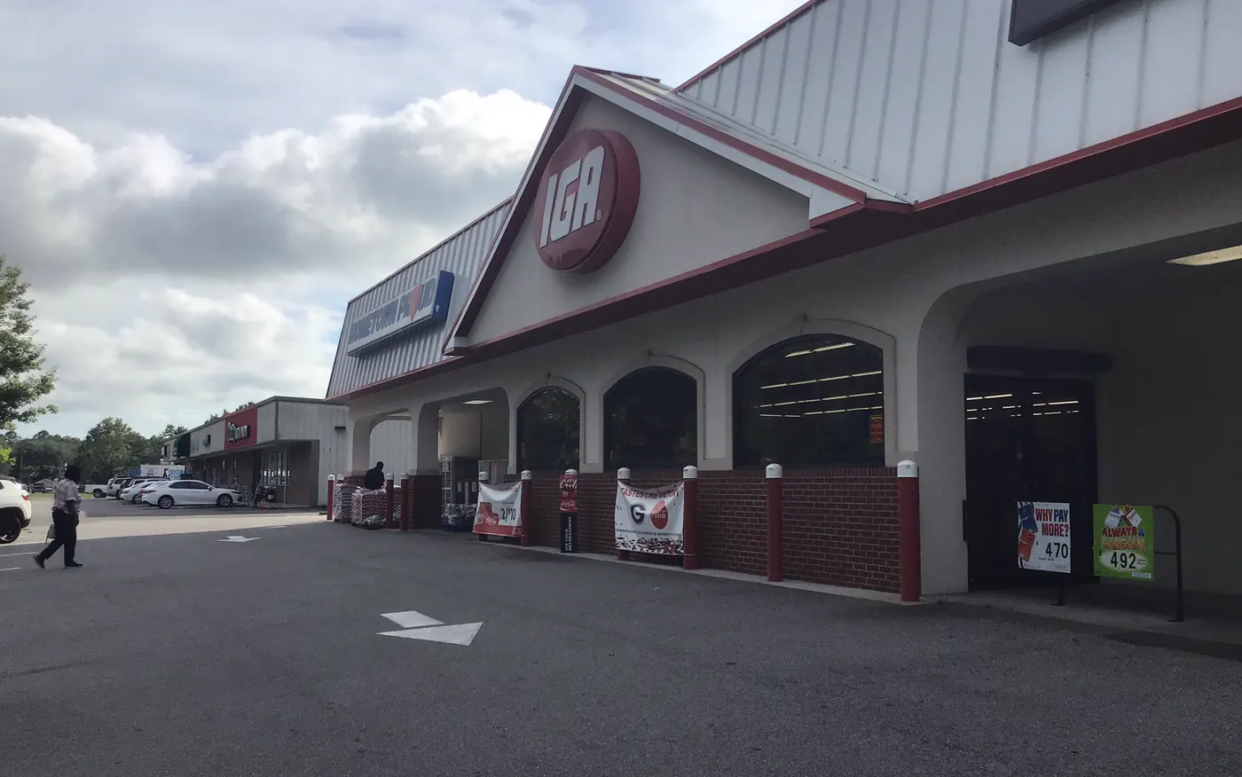 The IGA grocery store storefront and parking lot in Midway, Georgia